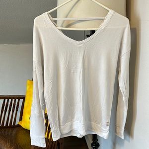 White long sleeve v- neck shirt. Open back with fun details